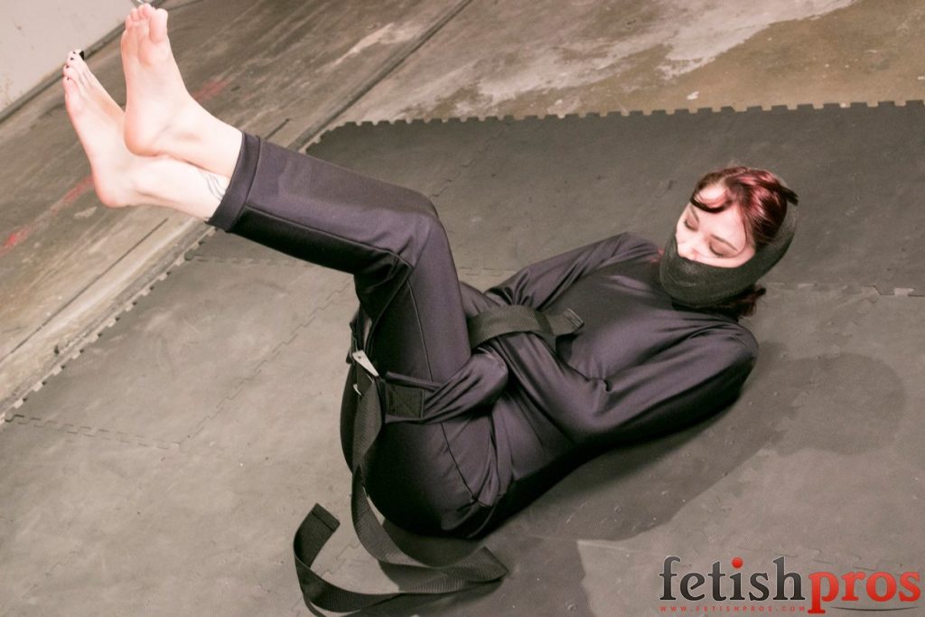 clad in blue full-body hobble straitjacket that leaves only her feet... 